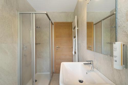 a bathroom with a sink and a shower at Premium App Hofer Monika in Villabassa