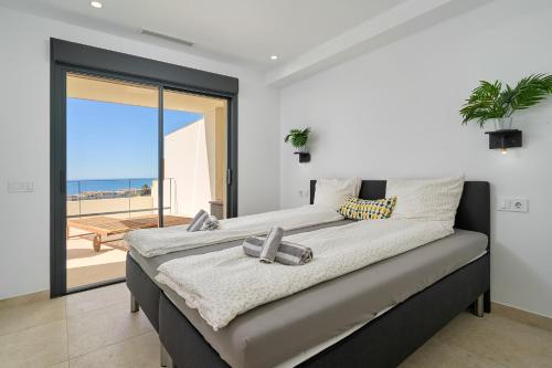 a bedroom with a bed with a view of the ocean at Exclusive Getaway – Ocean View in Torrox Costa