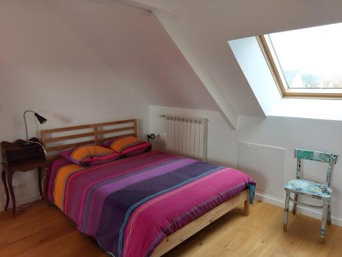 a bedroom with a bed and a large window at Chambre D'hôtes Lesseps in Vendôme