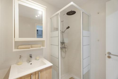 a white bathroom with a shower and a sink at Charming one bedroom Los Cristianos in Arona