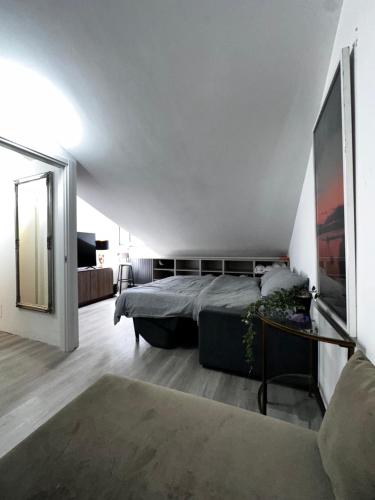 a bedroom with a large bed and a mirror at Nice and cozy apprtment in Murazzano with panoramic view in Murazzano