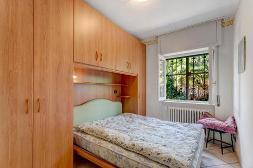 a bedroom with a bed and a window at Unique Lake View In Green Park in Nebbiuno