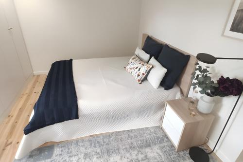 a white bed with pillows on it in a room at Douro Barcos House Local in Barcos