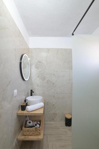 a bathroom with a sink and a mirror at Sunset View House In Chalkidiki in Nea Potidaea