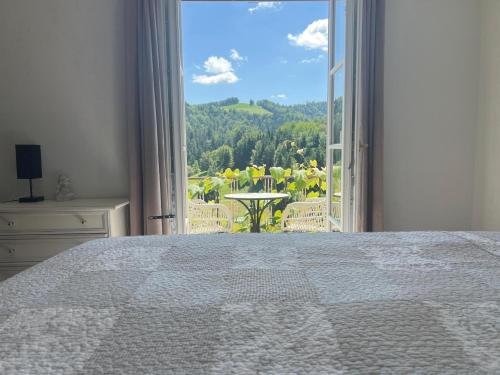 a bedroom with a bed and a large window at Weingut Kleinmonte in Leutschach