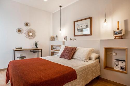 a bedroom with a bed and a table and a mirror at Casa Yerida in El Cotillo