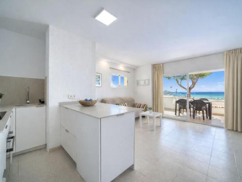 a kitchen and living room with a view of the ocean at Apartment Xisca by Interhome in Port d'Alcudia