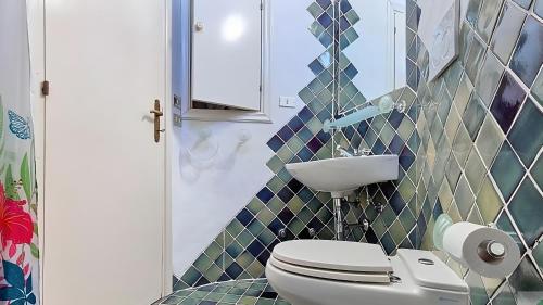 a bathroom with a toilet and a sink at Monolocale Porto Sole N 4 in Baja Sardinia