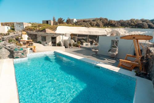 a swimming pool in the middle of a house at Rody Caves Oia in Oia