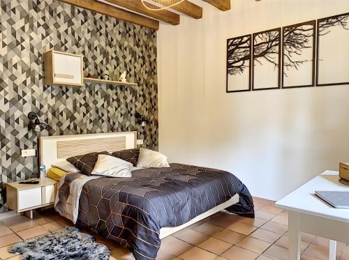 a bedroom with a bed in a room with a table at Le Chalêt La Neverdiere in Ygrande