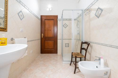 a bathroom with a sink and a toilet and a shower at Domus Luna in Giba