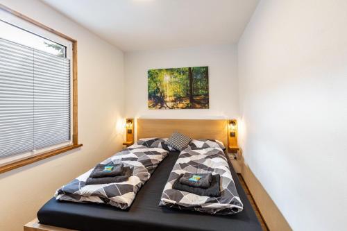 a bedroom with a bed in a room with a window at Ferienhaus Stauseeblick in Kelbra