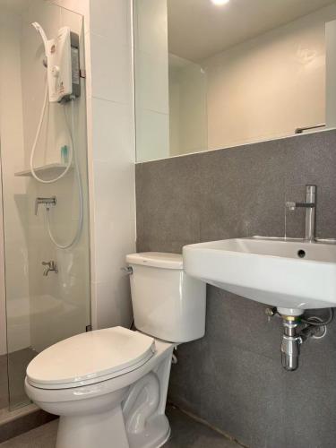 a bathroom with a toilet and a sink at 4 mins to MRT Sutthisan in Bangkok