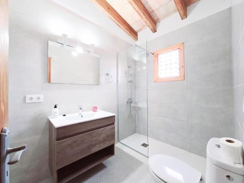 a bathroom with a sink and a shower and a toilet at Finca Boy in Pollença