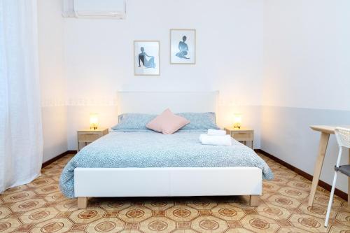 a bedroom with a bed and two night stands at Luna - Apartment by the beach in Lesa