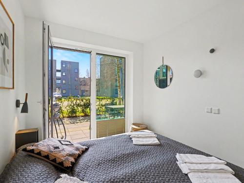 a bedroom with a bed and a large window at Apartment Seemomente - 615 by Interhome in Lembruch