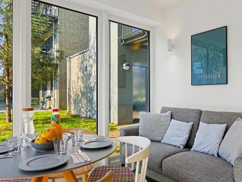 a living room with a table and a couch at Apartment Seemomente - 615 by Interhome in Lembruch