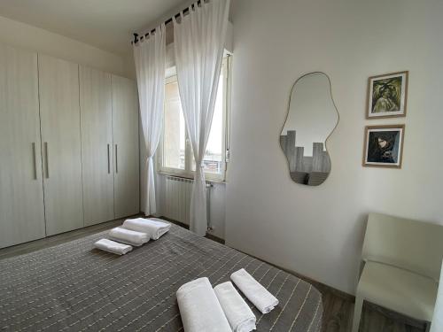 a bedroom with a bed with towels on it at A7 Trilocale Fronte Mare in Marina di Grosseto