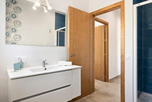 a bathroom with a sink and a mirror at Villa Montemedio - Paco in El Soto