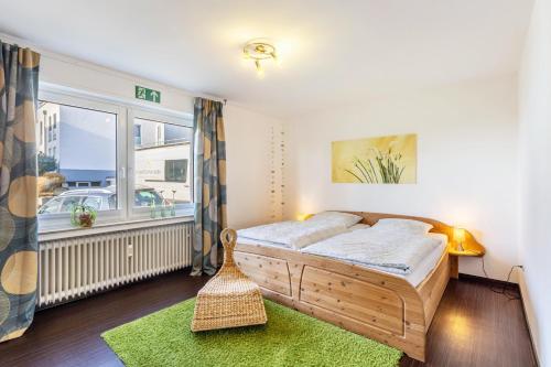 a bedroom with a bed and a window at Ferienwohnung In den Haargärten in Möhnesee