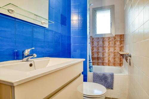 a blue bathroom with a sink and a toilet at Nice apartment with terrace in Lloret de Mar