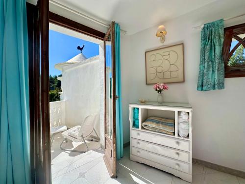 a room with a white dresser and a window at La Casa Turquesa in Frigiliana