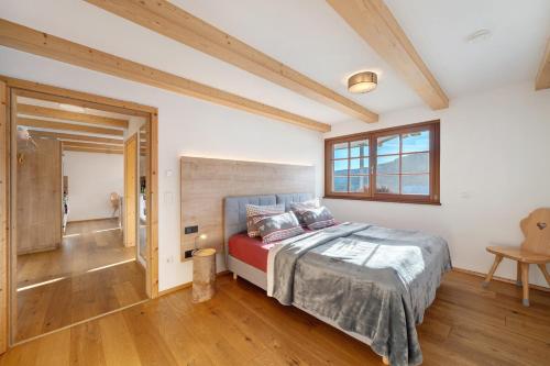 a bedroom with a large bed and a window at Ferienwohnung Holzfäller in Lenzkirch