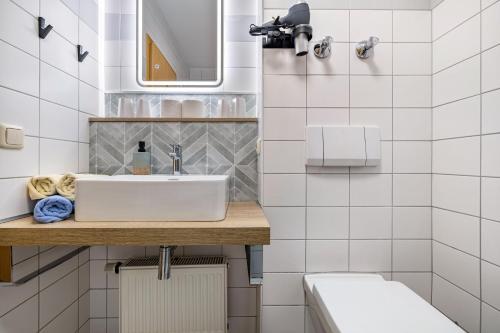 a bathroom with a sink and a toilet at Fewo Brünnstein - Nr 27 Pool, Sauna in Oberaudorf