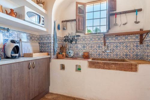 a kitchen with a sink and a window at Can Bonjesus in Felanitx