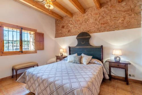 a bedroom with a large bed in a room with wooden ceilings at Can Bonjesus in Felanitx