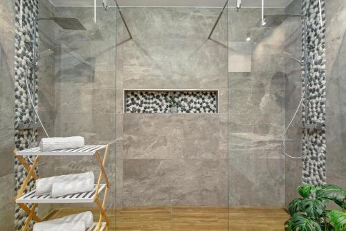 a shower with a glass door in a bathroom at O Marinheiro 15A in Caniçal