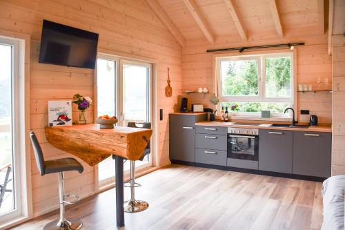 a kitchen with wooden walls and a wooden floor at Panoramahisli 4 in Fischerbach