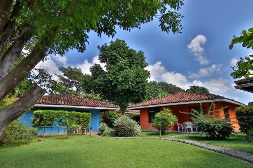 a house with a red and blue house at Hotel Bahia Esmeralda in Potrero