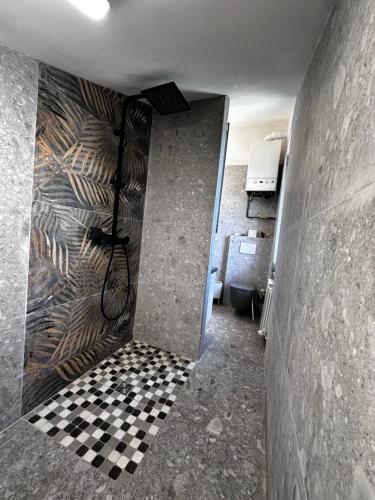 a bathroom with a shower with a checkered floor at Nice and cozy apprtment in Murazzano with panoramic view in Murazzano