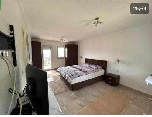 a bedroom with a bed and a flat screen tv at Villa Ilijas 3 bedrooms in Ilijaš