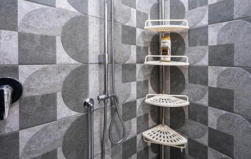 a bathroom with a shower with a shower head at P&P Apartment in Forio d'Ischia