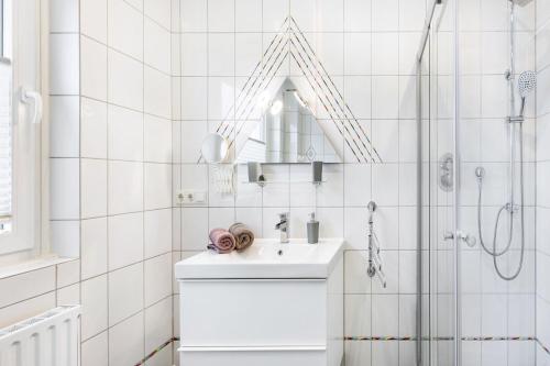 a white bathroom with a sink and a shower at Ferienwohnung Brune in Schmallenberg