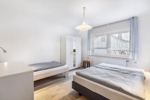 a bedroom with two beds and a window at Ferienwohnung Brune in Schmallenberg