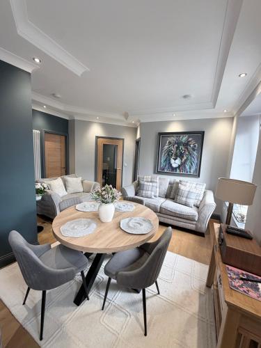 a living room with a table and a couch at Stylish Maisonette with View in Tweedmouth