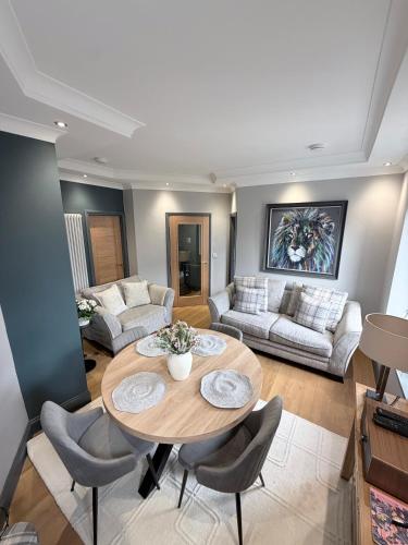 a living room with a wooden table and chairs at Stylish Maisonette with View in Tweedmouth
