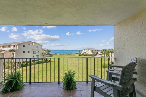 a chair on a balcony with a view of the ocean at Santa Rosa Dunes 923 in Pensacola Beach
