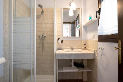 a bathroom with a sink and a shower at Cobijadas75 Janda in Vejer de la Frontera