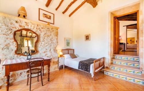 a bedroom with a bed and a desk and a mirror at Son Gabriela in Llucmajor