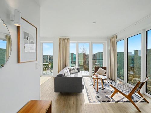 a living room with a couch and a table at Apartment Penthouse Dümmerblick - 619 by Interhome in Lembruch