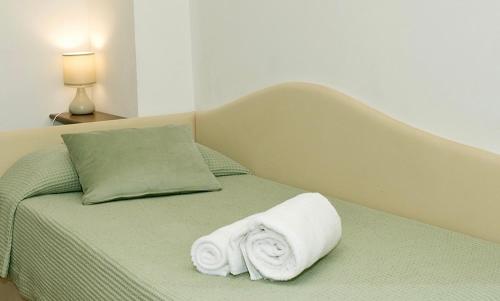 a bed with two towels on top of it at Masseria La Porticella in Avetrana