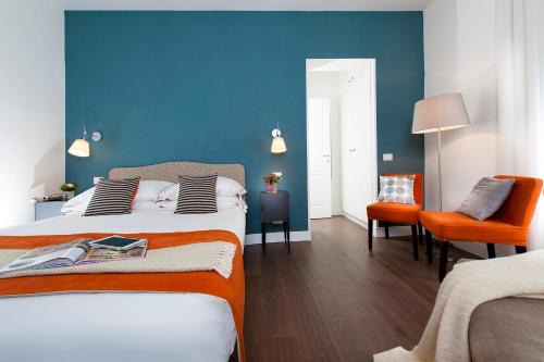 a bedroom with two beds and a blue wall at Corso Vittorio 308 in Rome