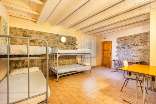 a room with two bunk beds and a table at Rectoria de Claverol in Claverol