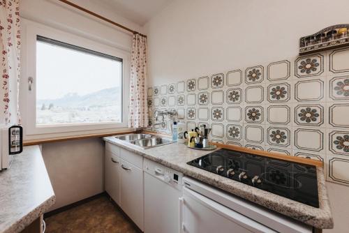 a kitchen with a sink and a window at Unterhauserhof App A in Valdaora