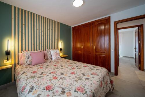 a bedroom with a bed with a floral bedspread at Mar in Playa Honda