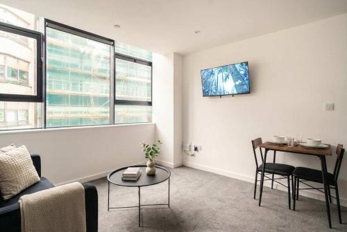 a living room with a couch and a table at Fantastic Central Preston 1 Bedroom Apartment in Preston